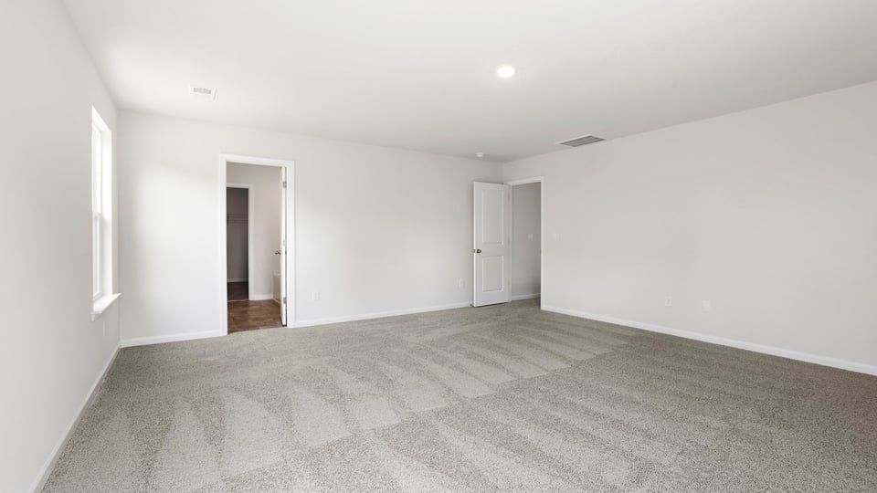 Bedroom with carpet and wiindow.