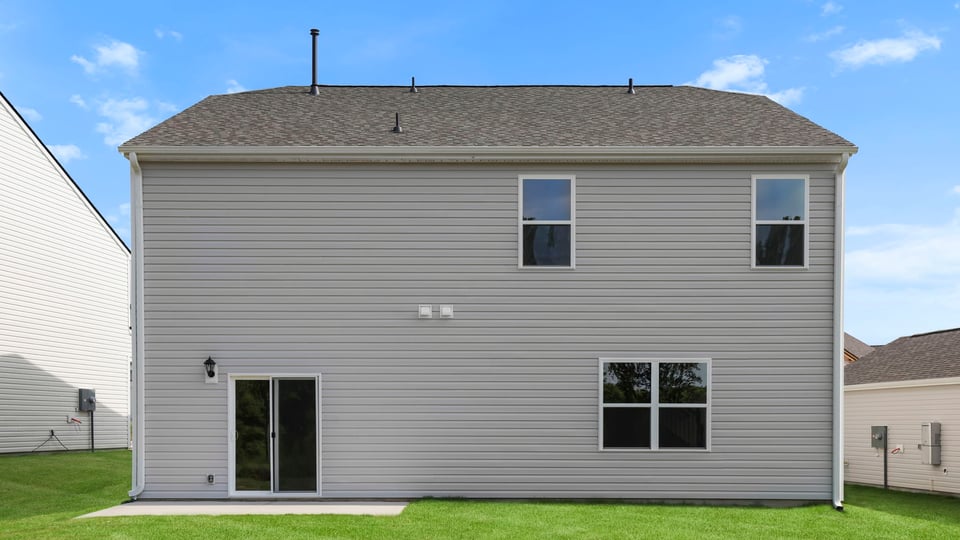 Exterior of home with large backyard.