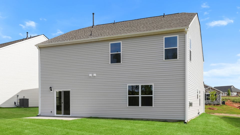 Exterior of home with large backyard.