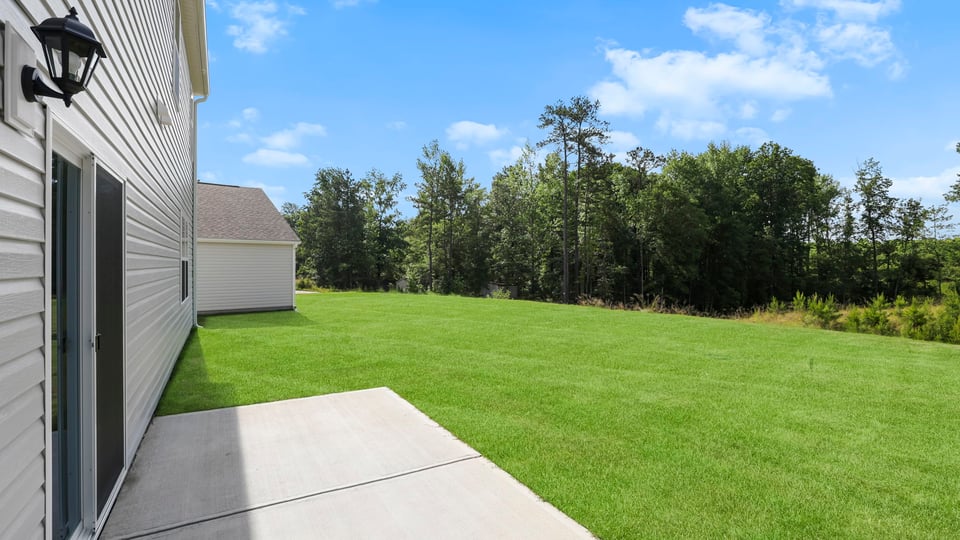 Exterior of home with large backyard.