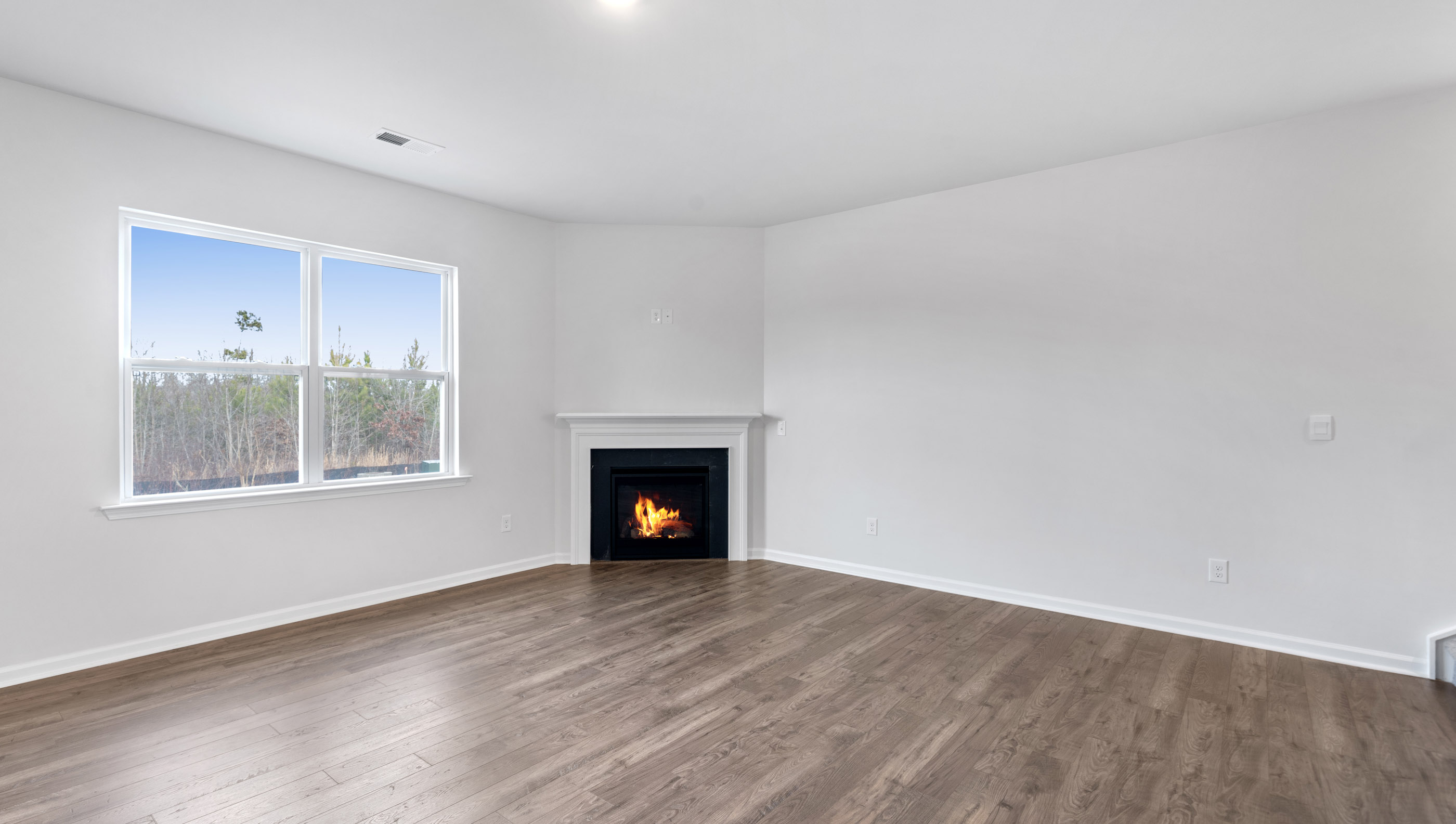 Family room with fireplace and windows.