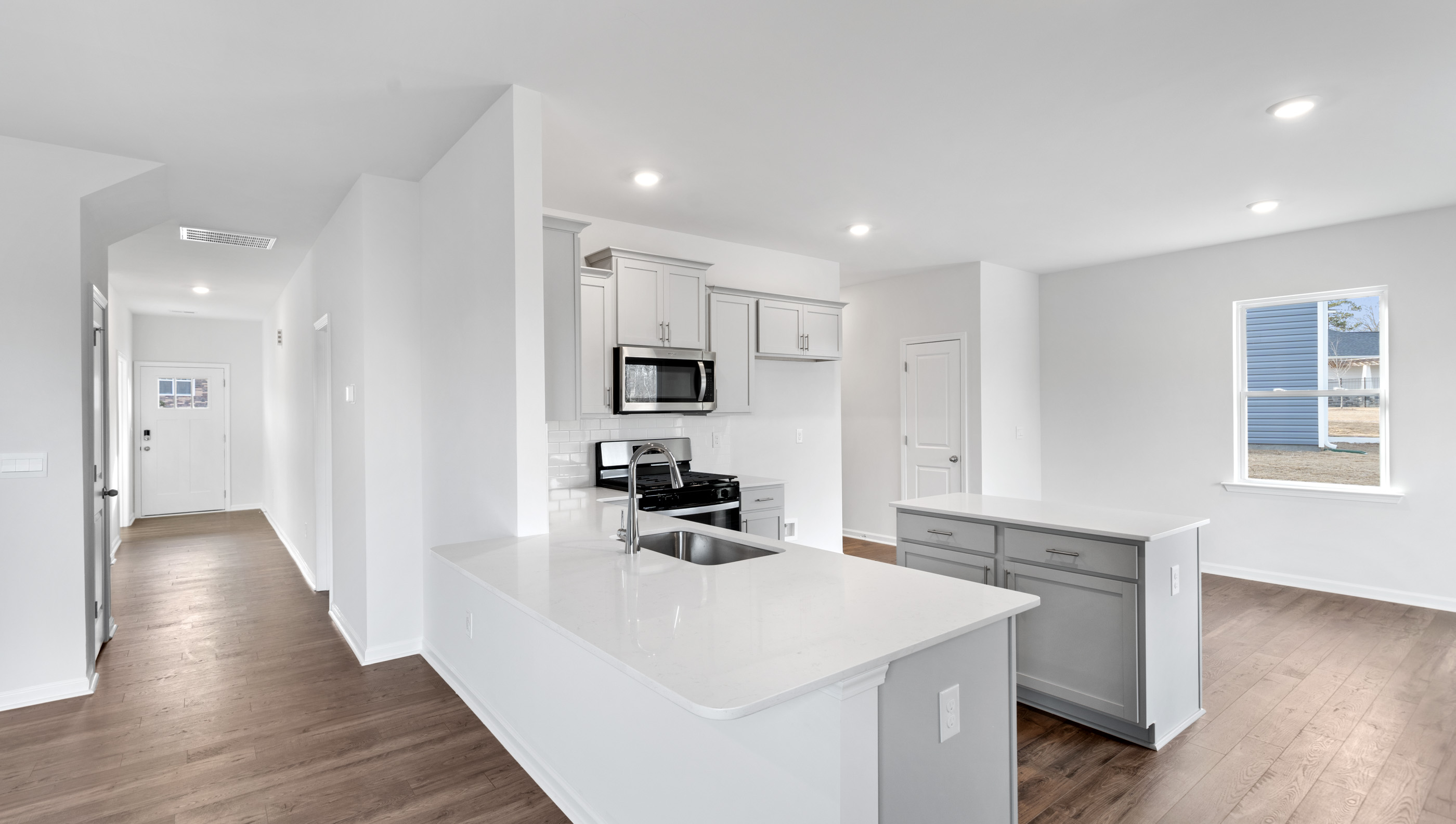 Kitchen and island with granite counter tops.