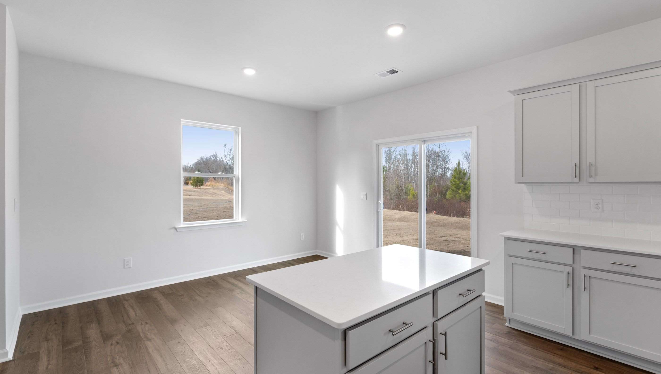 Kitchen and island with granite counter tops.