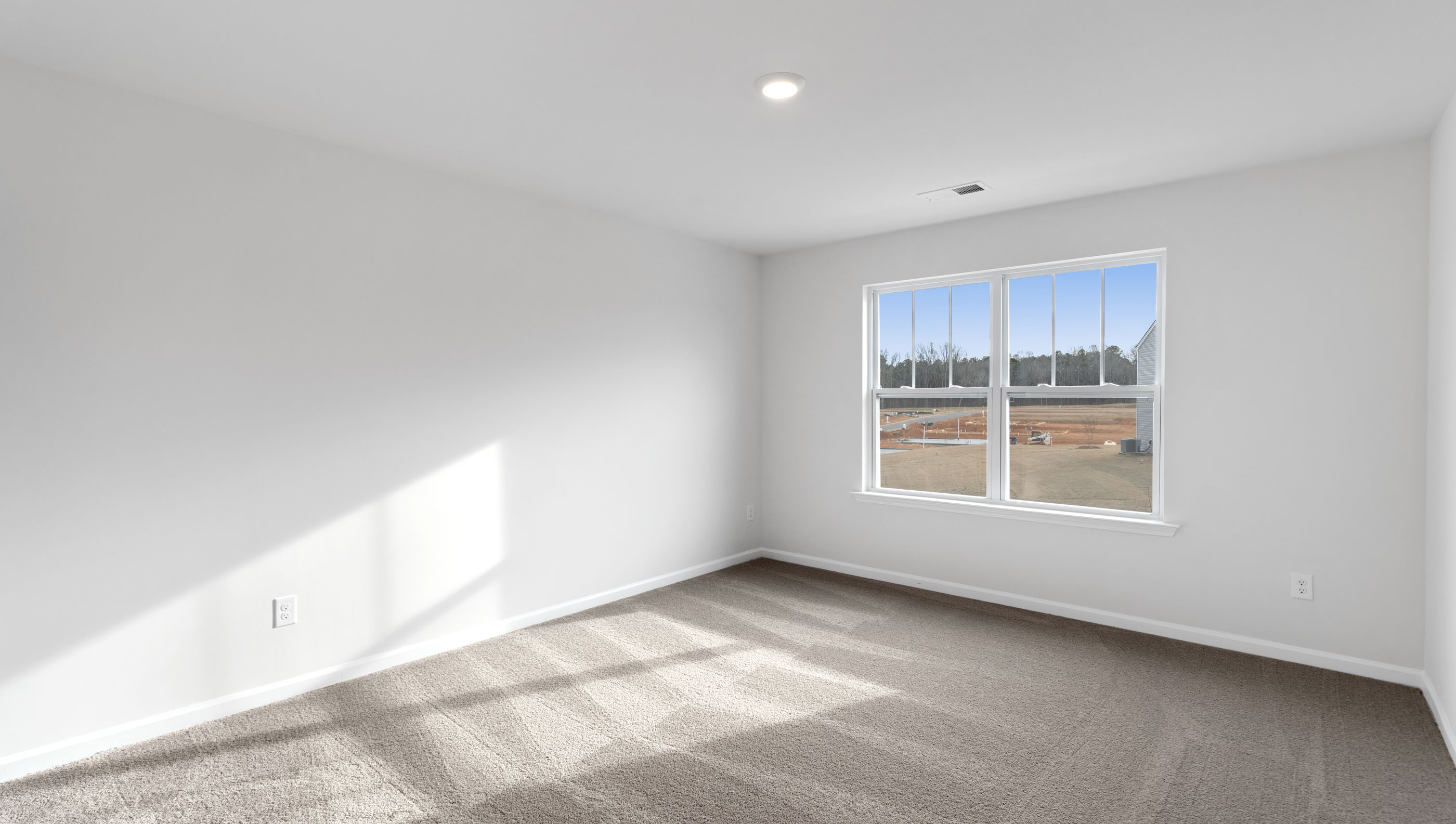 Bedroom with carpet and windows.