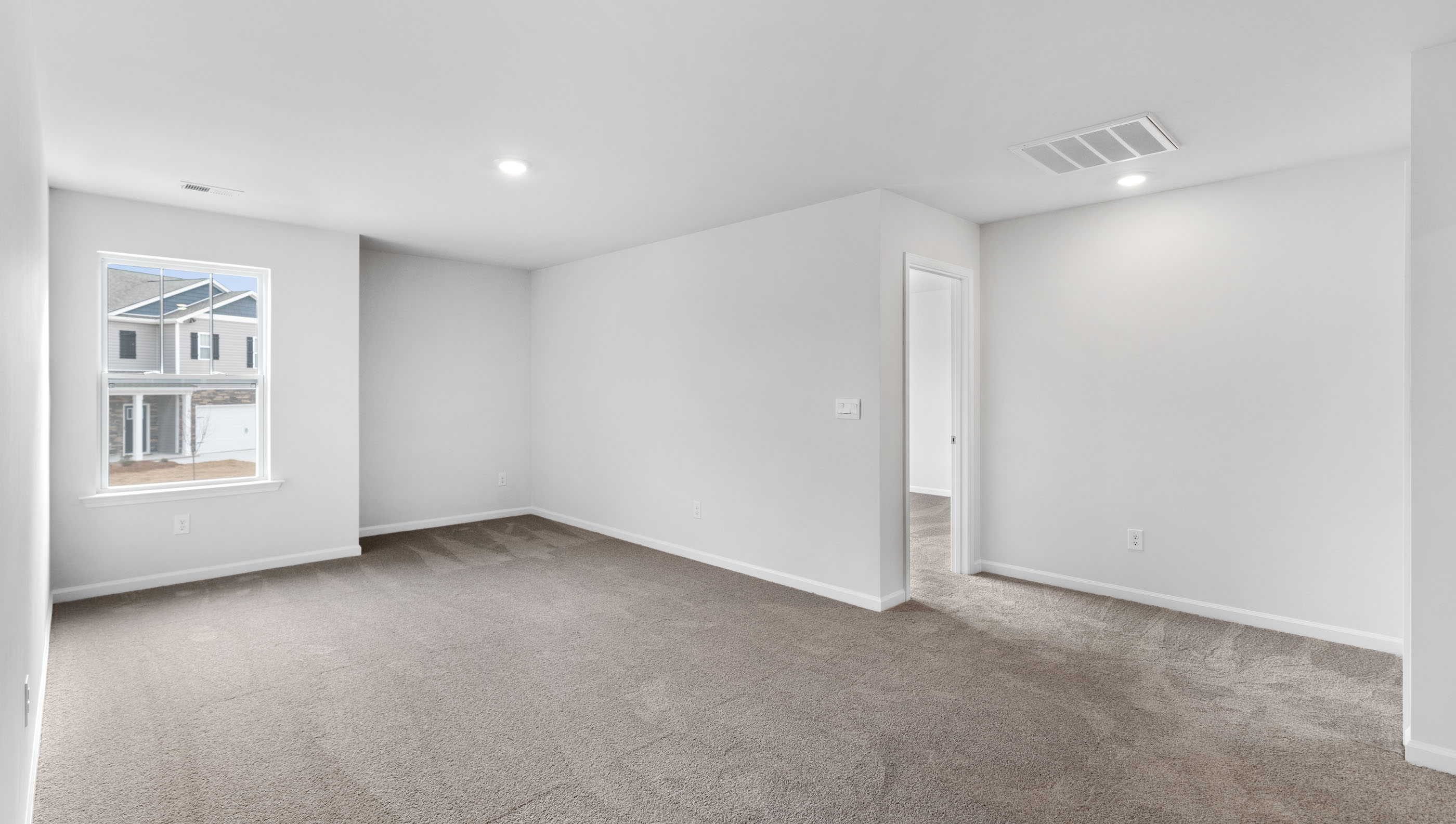 Bedroom with carpet and windows.