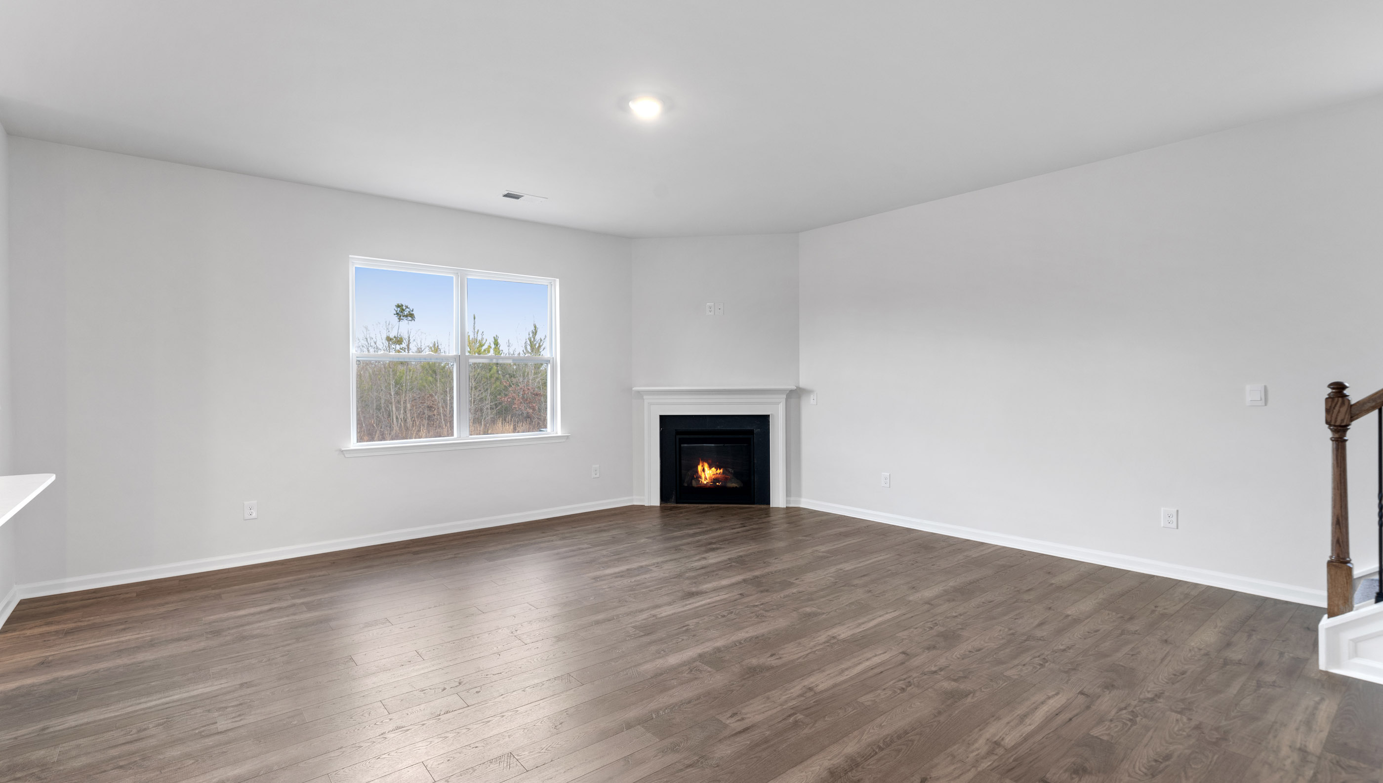 Family room with fireplace and windows.