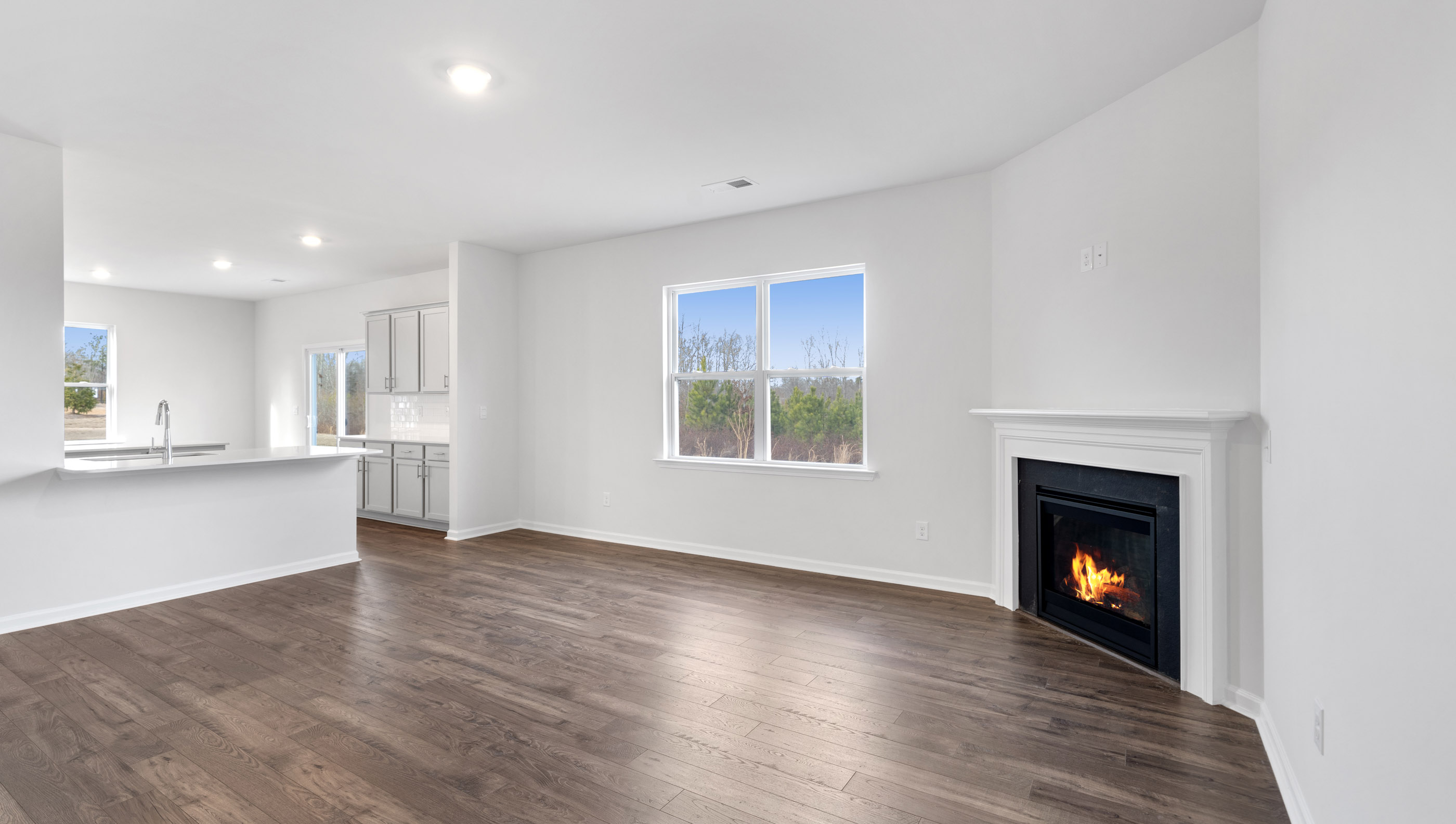Family room with fireplace and windows.