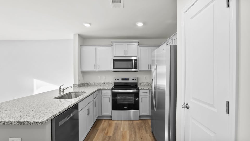 Kitchen with stainless steel appliances and granite counter tops.