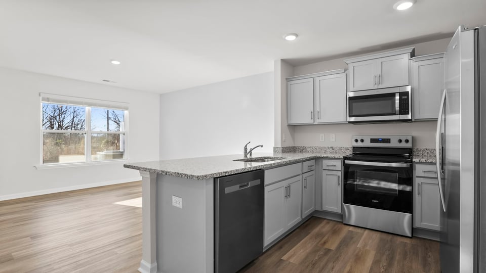 Kitchen with granite counter tops and stainless steel appliances.