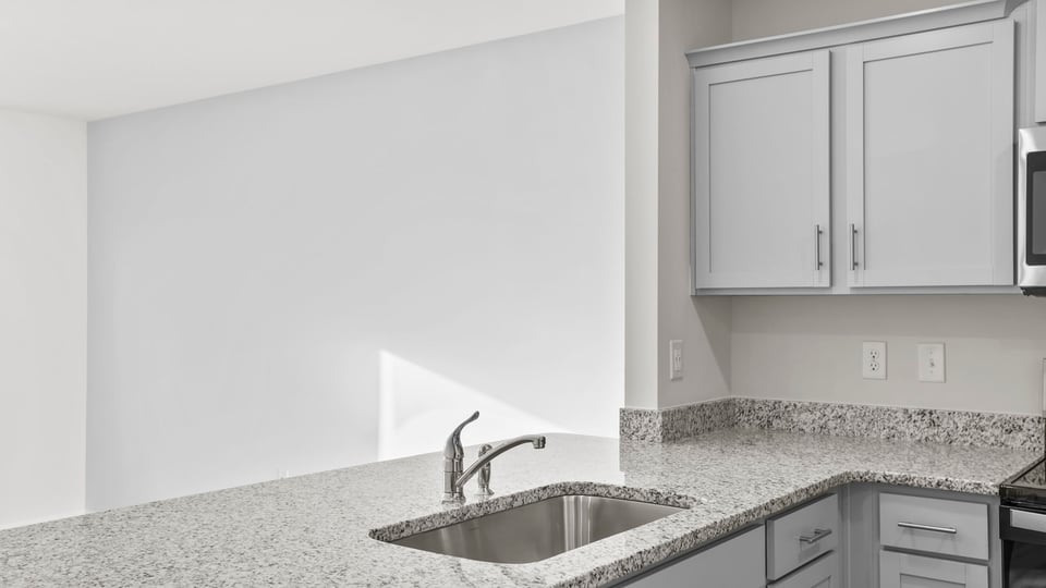 Kitchen with granite counter tops and stainless steel appliances.