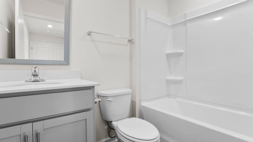 Bathroom with single vanity sink and tub.