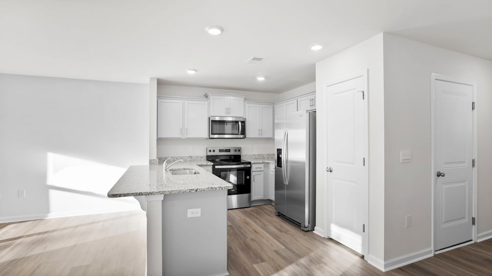 Kitchen with granite counter tops and stainless steel appliances.