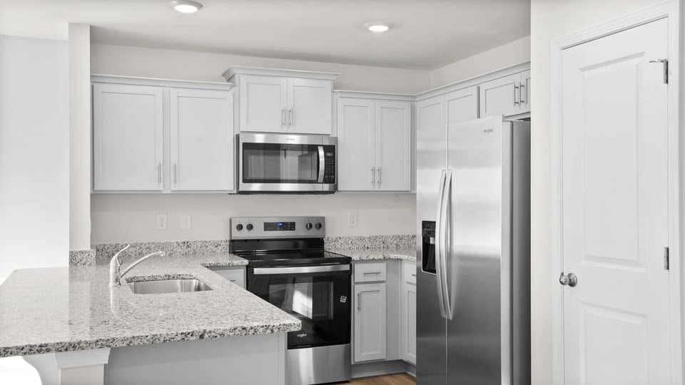 Kitchen with granite counter tops and stainless steel appliances.