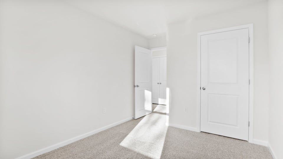 Bedroom with carpet and window.