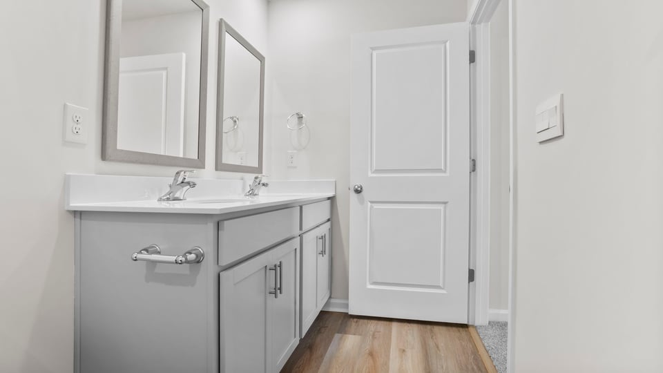 Bathroom with double vanity sink and walk in shower.