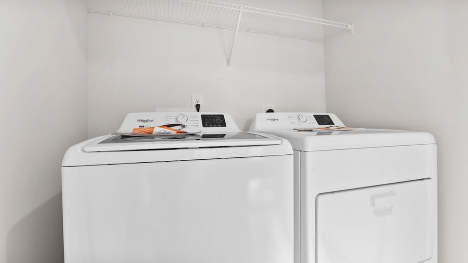 Laundry room with hanging storage racks.