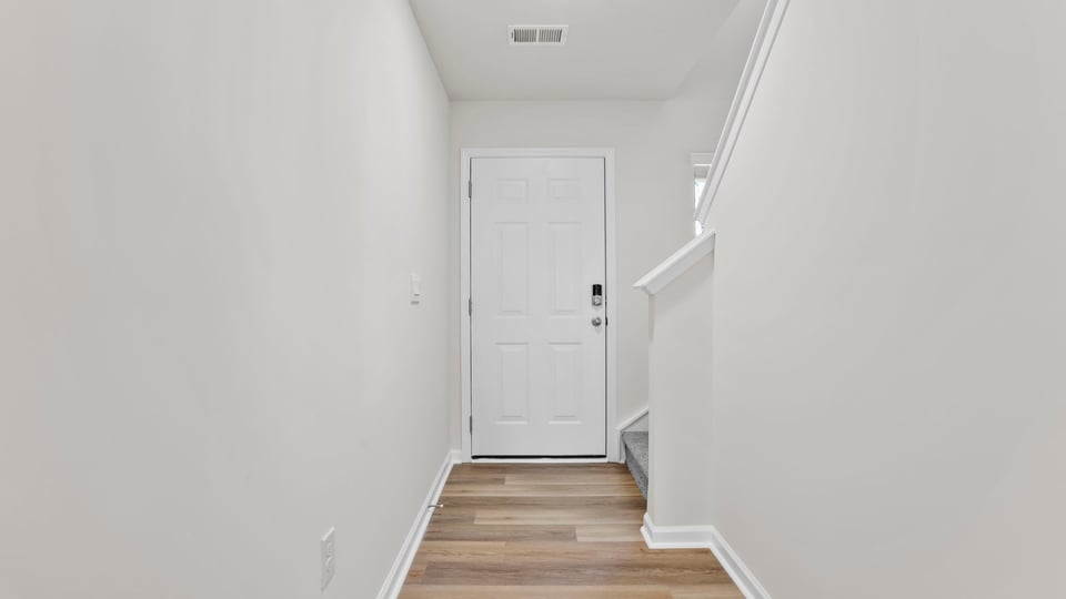 Hallway into home with view of rooms.