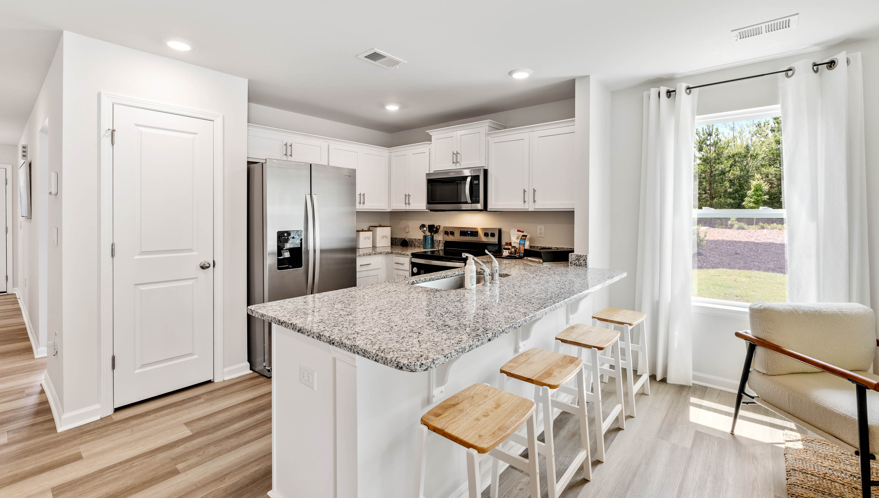 Kitchen with quartz countertops and stainless steel appliances.