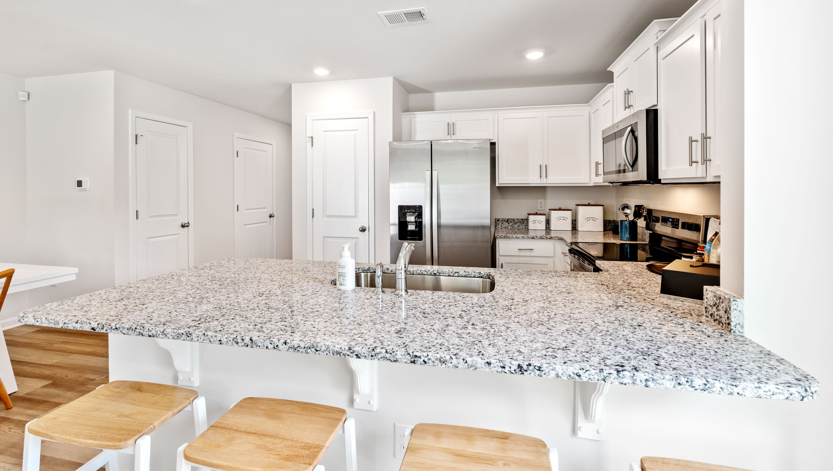 Kitchen with quartz countertops and stainless steel appliances.
