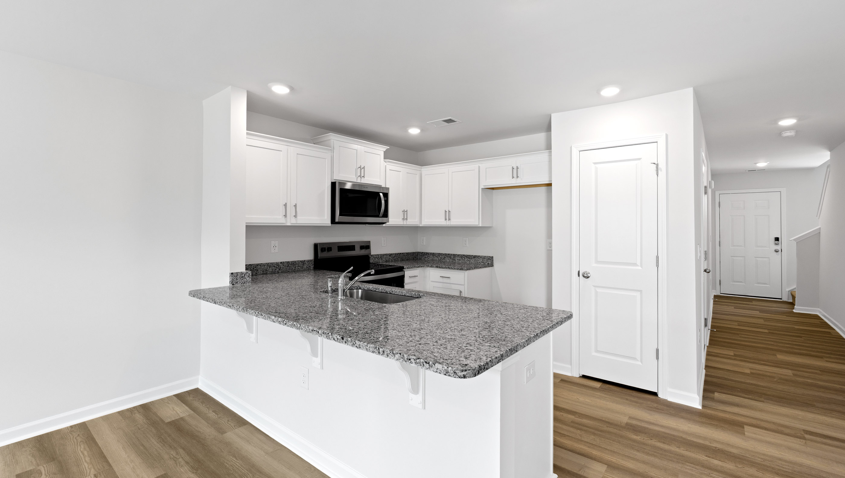 Kitchen with granite countertops and stainless steel appliances.