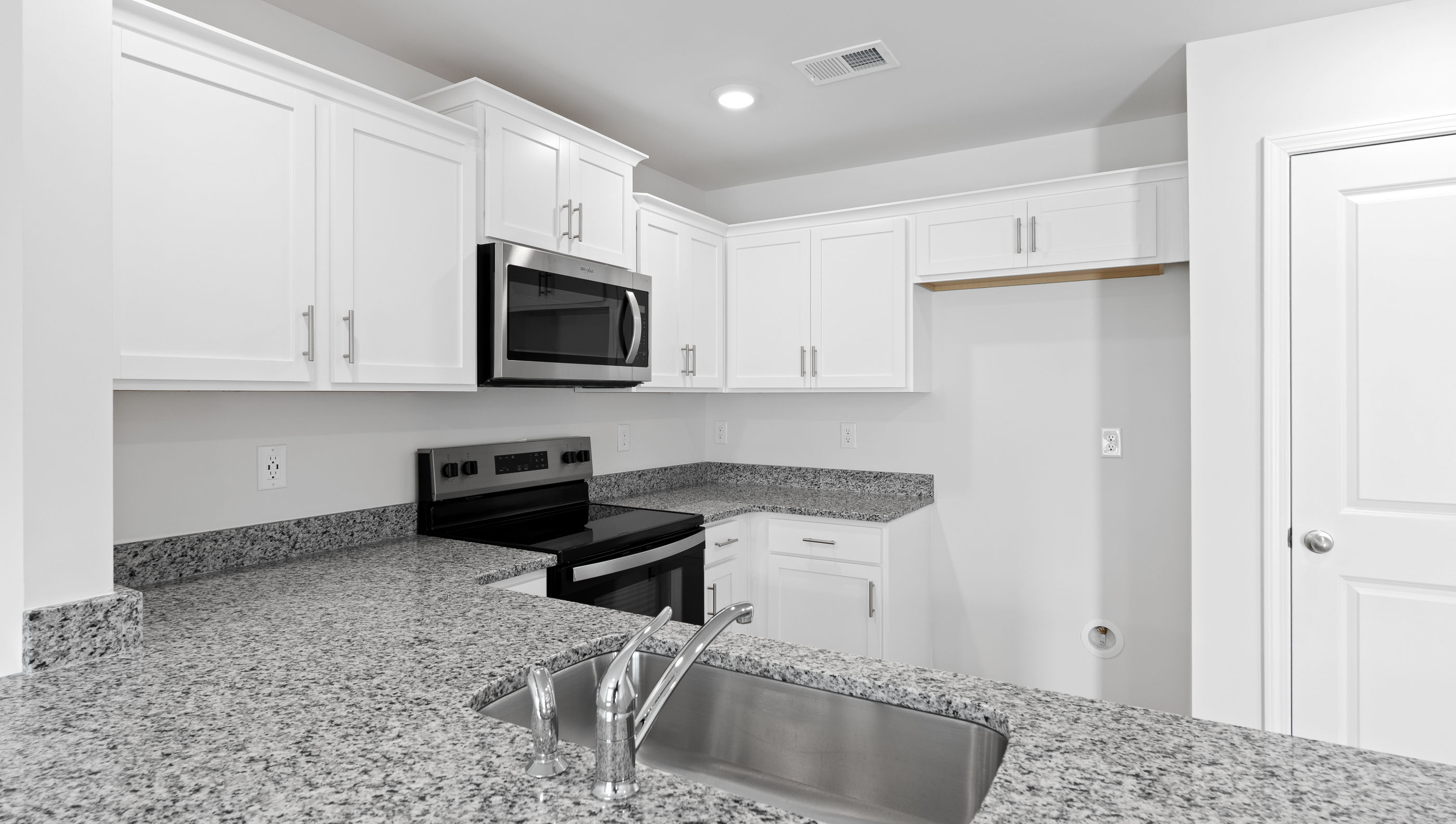 Kitchen with granite countertops and stainless steel appliances.