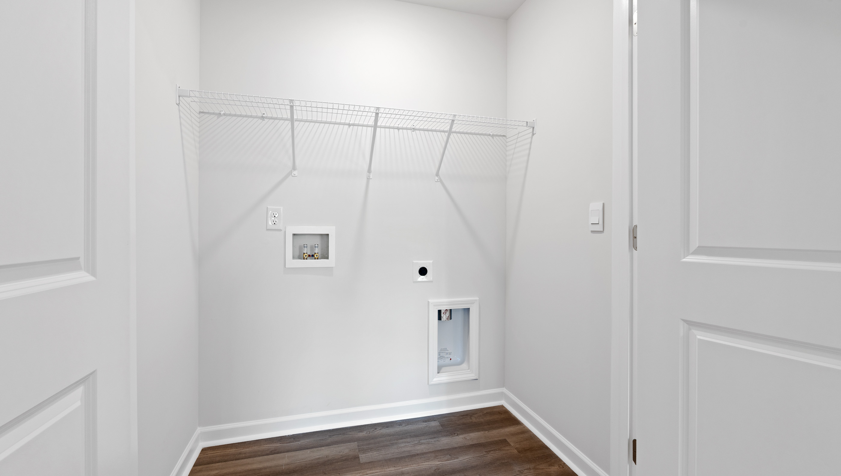 Walk in closet with shelves.