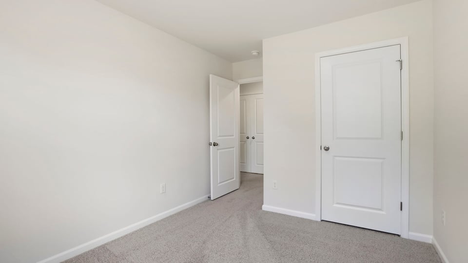 Bedroom with carpet and window.