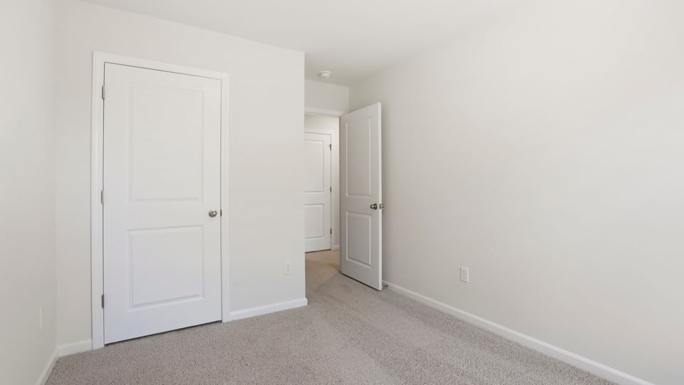 Bedroom with carpet and window.
