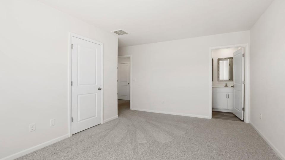 Bedroom with carpet and window.