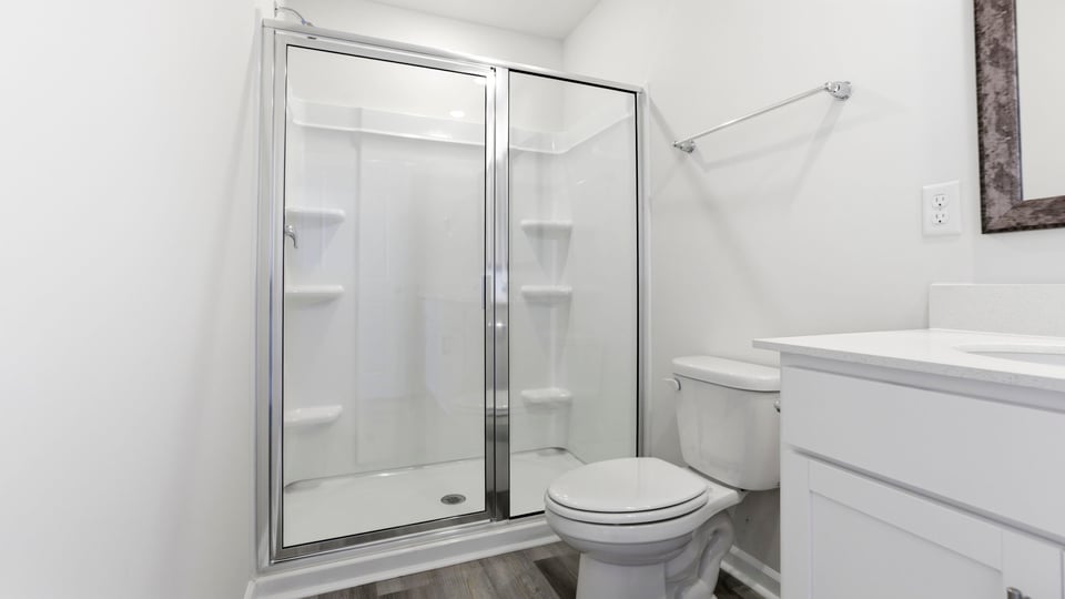 Bathroom with double vanity and walk in shower.