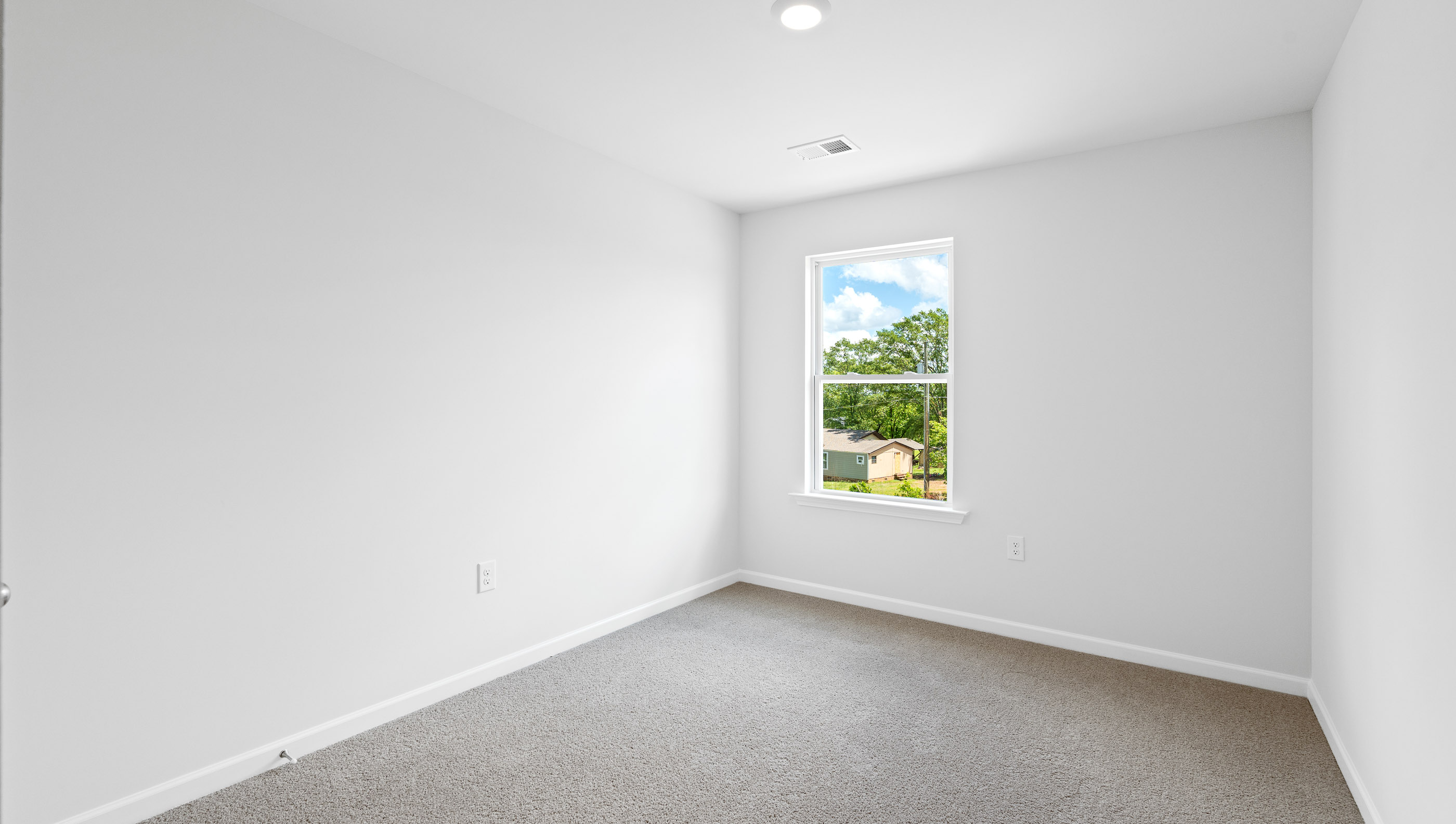 Bedroom with carpet and windows.
