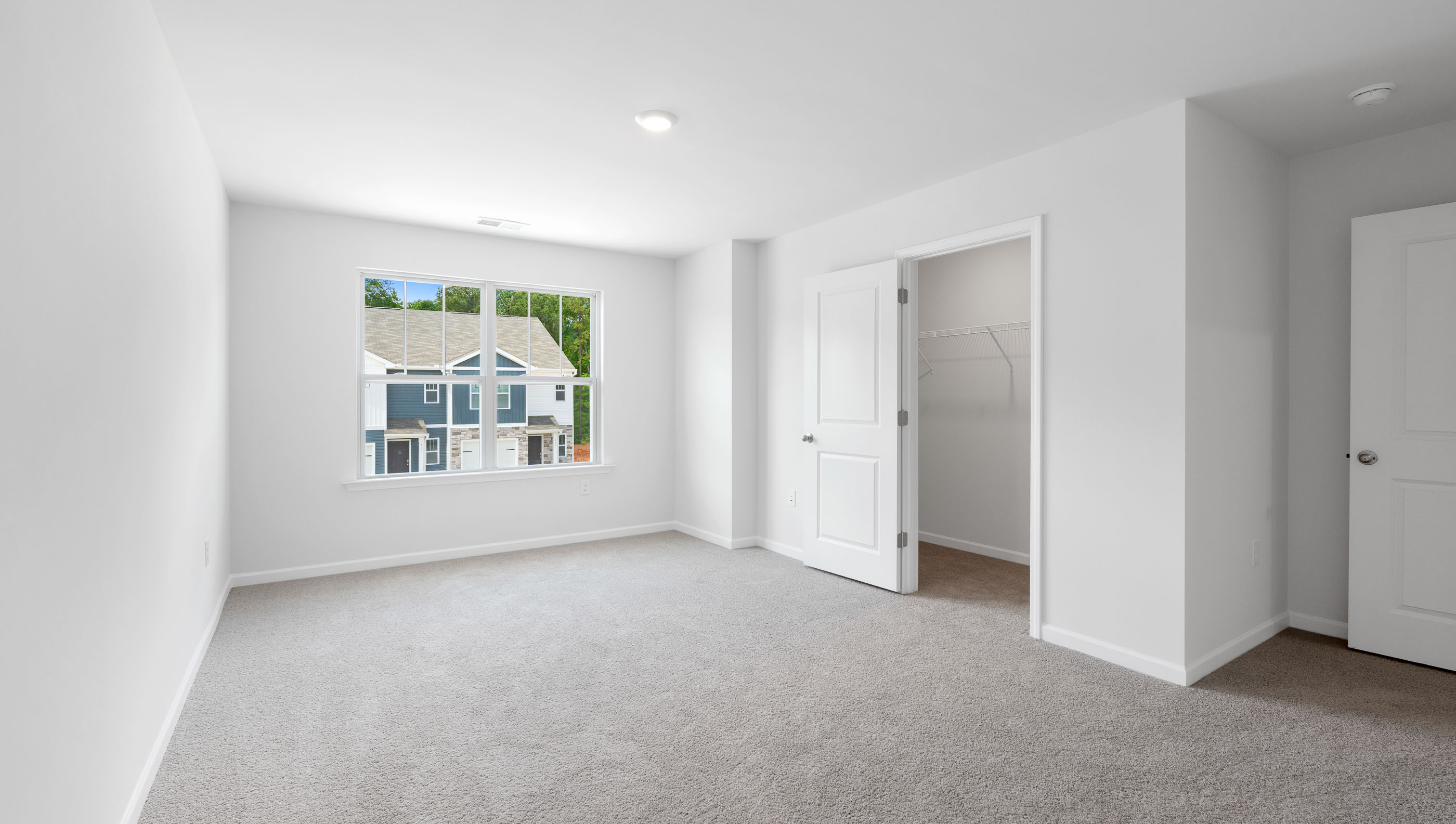 Bedroom with carpet and windows.