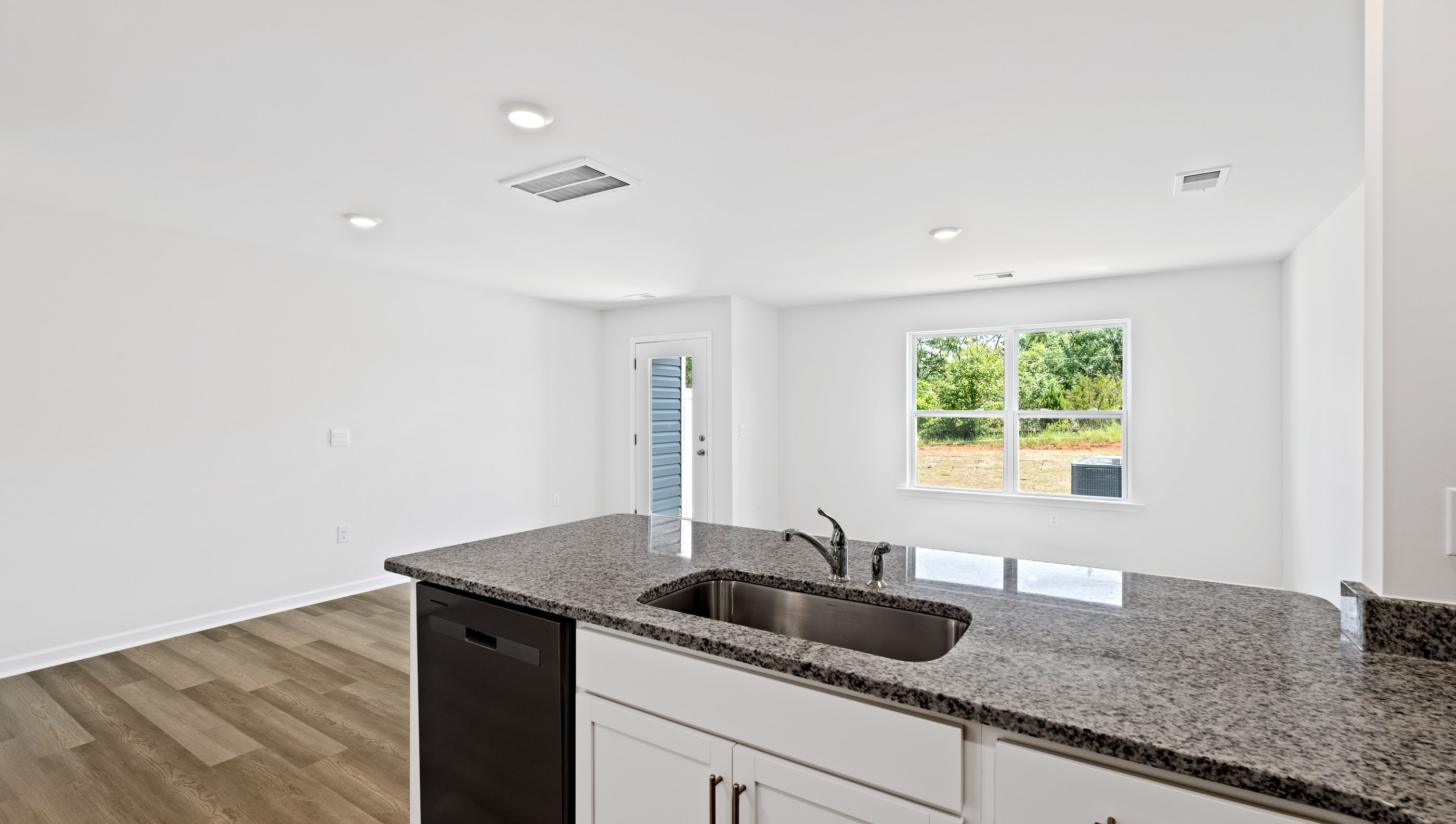Kitchen with granite countertop and stainless steel appliances.