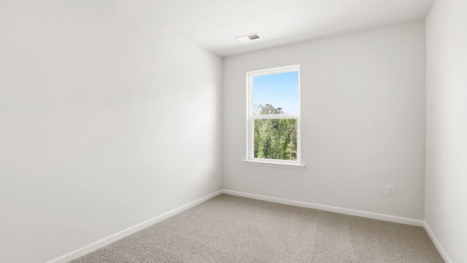 Bedroom with carpet and window.