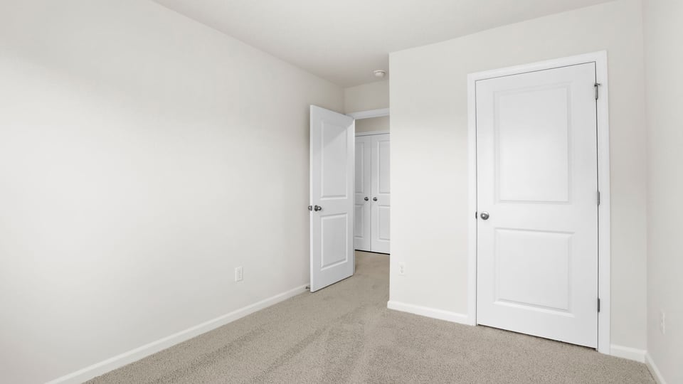 Bedroom with carpet and window.