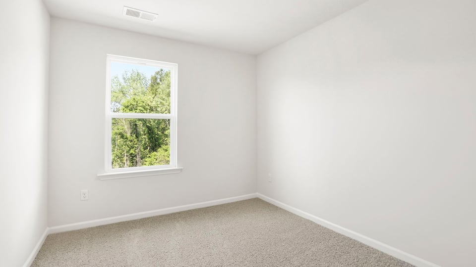 Bedroom with carpet and window.