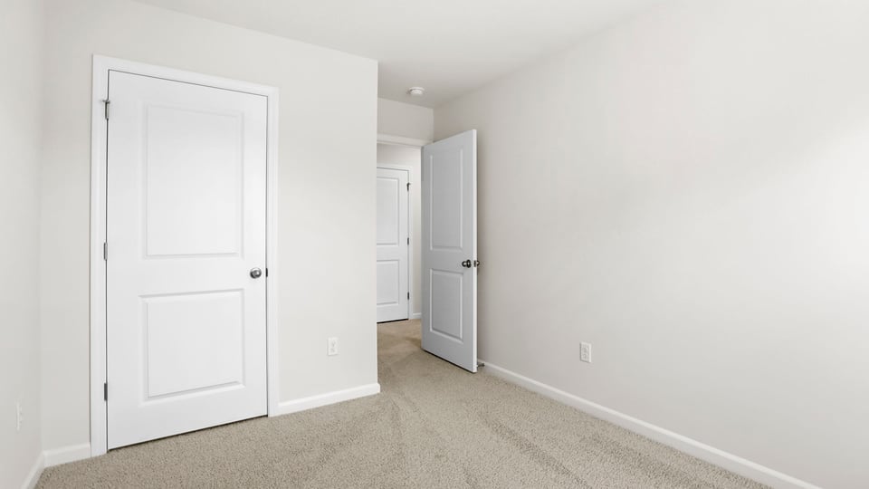 Bedroom with carpet and window.