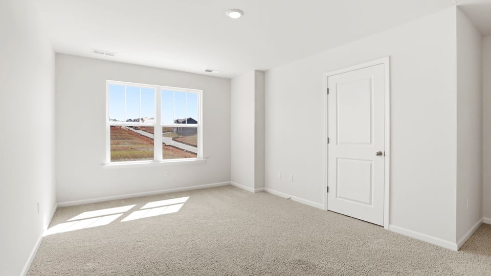 Bedroom with carpet and window.
