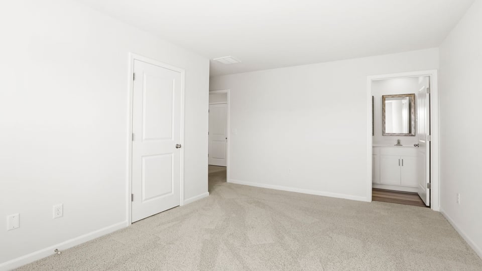 Bedroom with carpet and window.