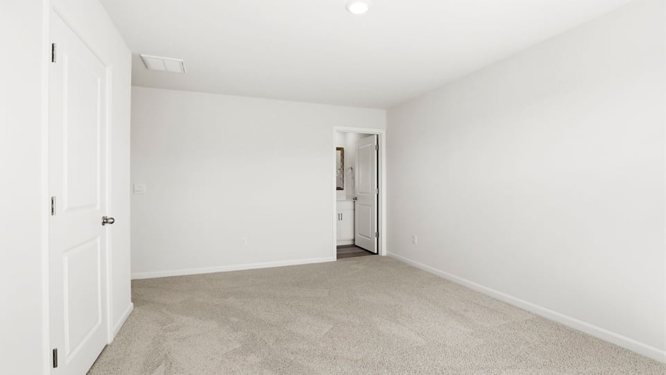 Bedroom with carpet and window.