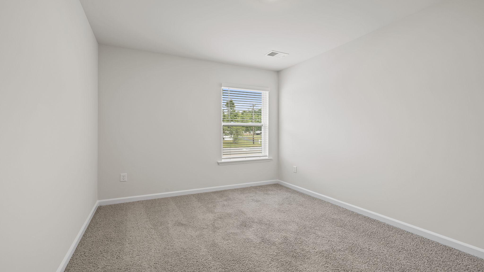 Bedroom with carpet and window.