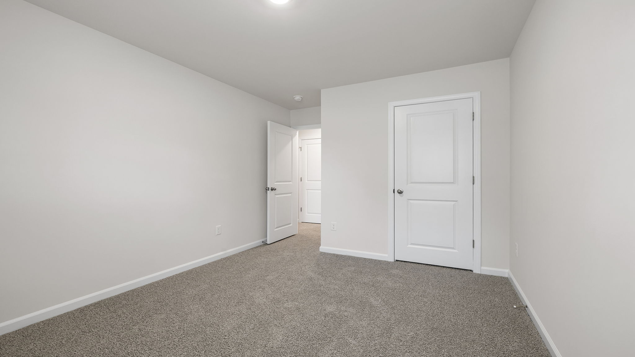 Bedroom with carpet and window.