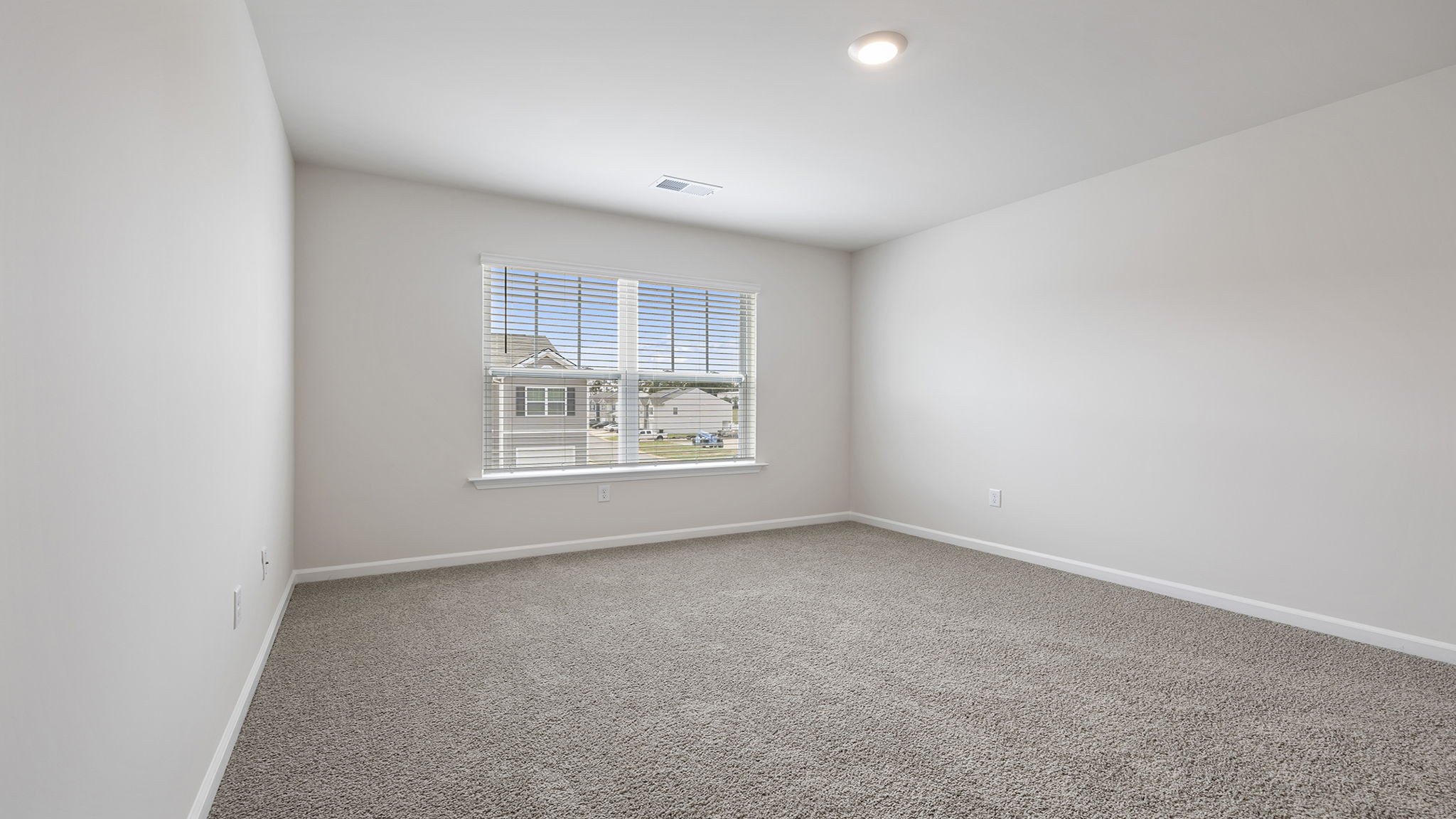 Bedroom with carpet and window.