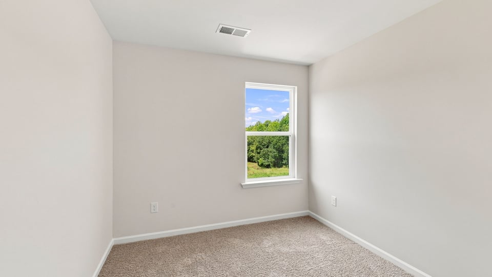 Bedroom with carpet and window.