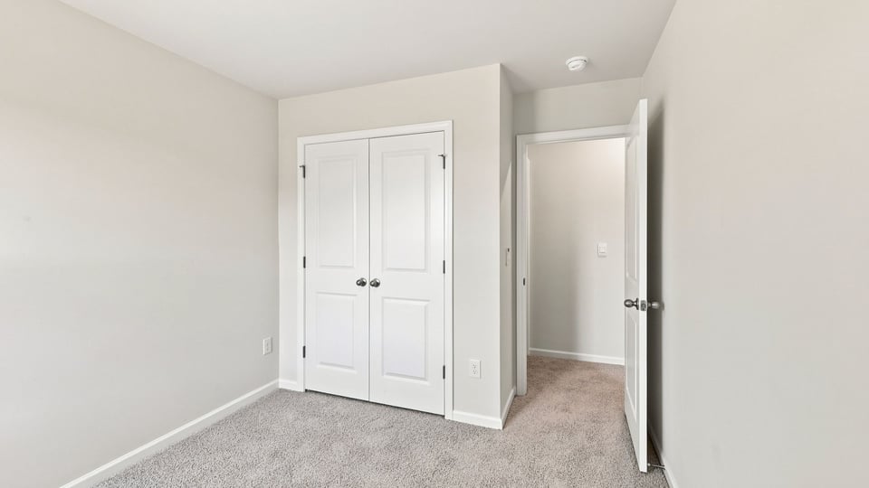 Bedroom with carpet and window.