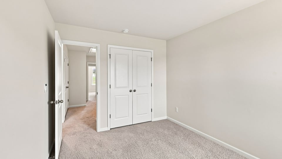 Bedroom with carpet and window.