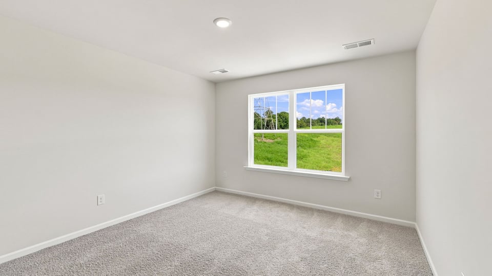 Bedroom with carpet and window.