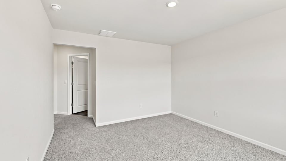 Bedroom with carpet and window.