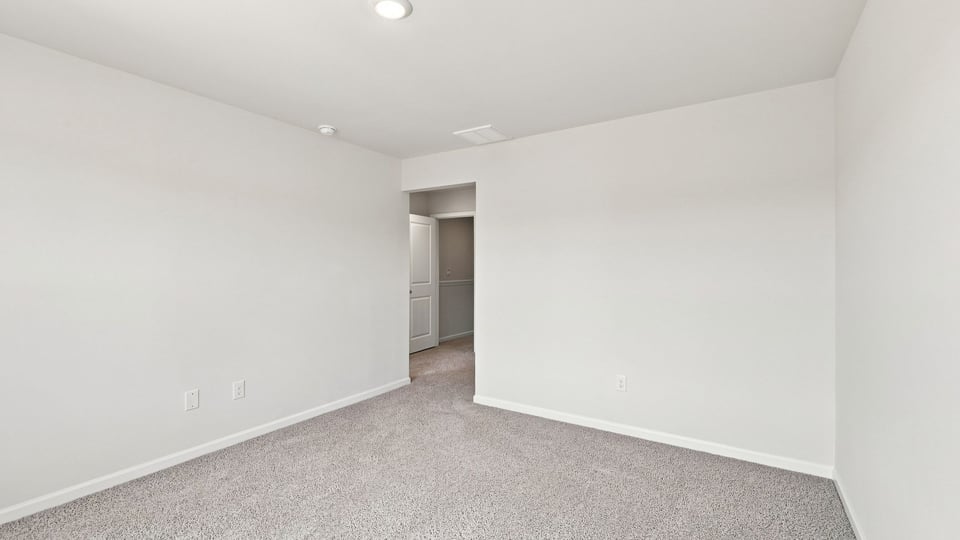 Bedroom with carpet and window.