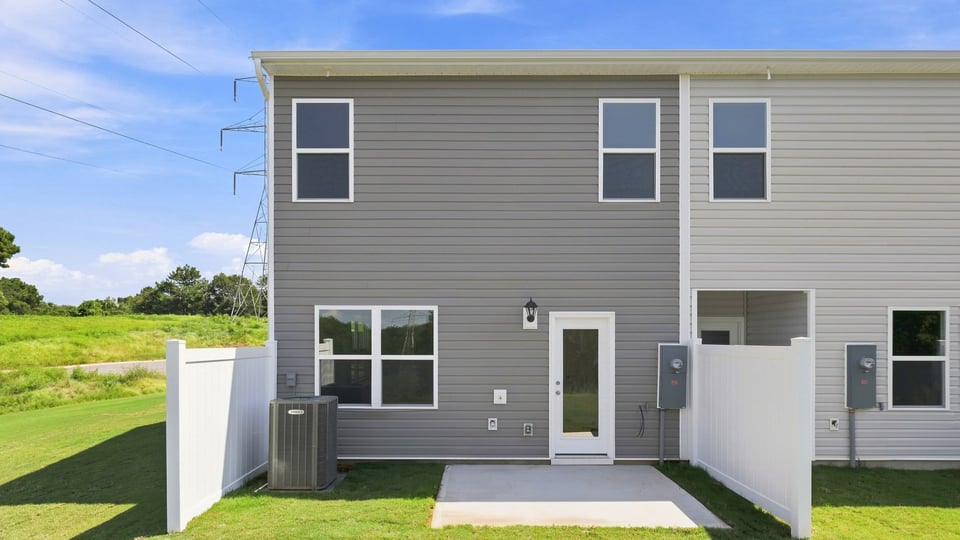 Back exterior of home with large backyard.